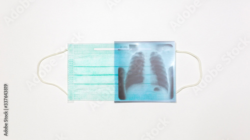 Respiratory surgical mask and lung x-ray film on white background
