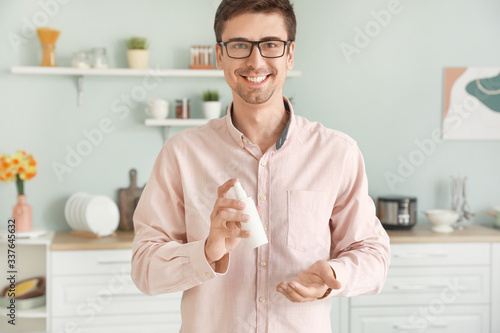 Man with disinfectant at home