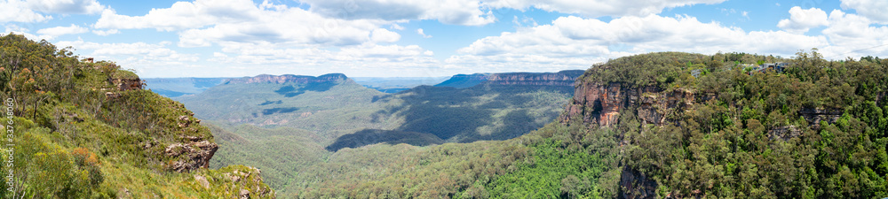 Panoramic Blue Mountains Australia. Dramatic views of peaks, rock, valley, landscape, green rainforest jungle. Adventure, freedom, fun concepts. Tourist mountain trek. Shot in Sydney, NSW.