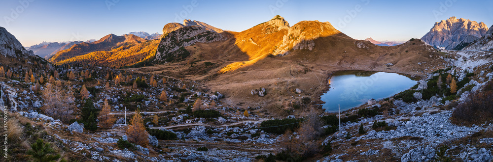 Early morning autumn alpine Dolomites mountain scene. Peaceful Valparola Pass and Lake view, Belluno, Italy.