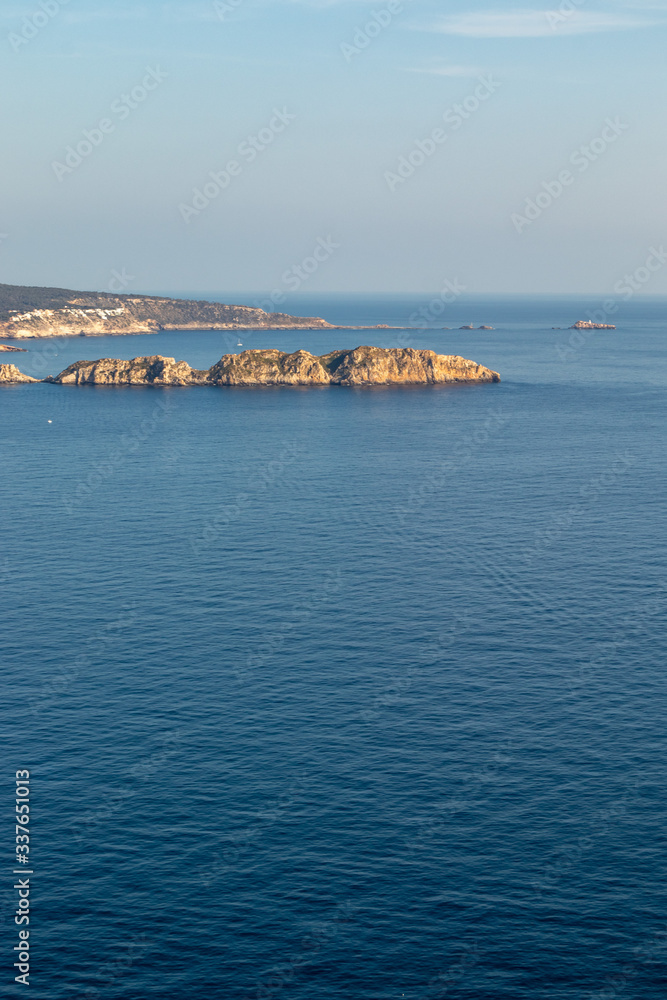 aerial view over Rocks, cliffs, island and sea water during sunset from the view point cap andritxol in Camp de Mar, Majorca island, Spain