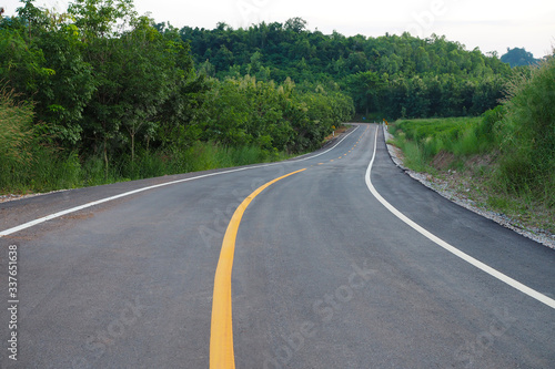 Asphalt road cut through the mountain in thailand