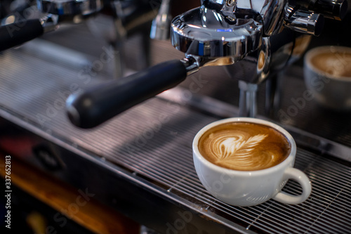 coffee latte on espresso machine in coffee shop 