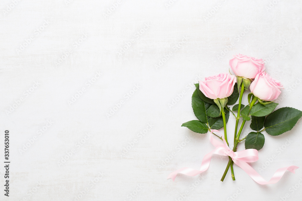 Flowers valentine day composition. Frame made of pink rose on gray background. Flat lay, top view, copy space. Flowers valentine day composition. Frame made of pink rose on gray background. Flat lay, top view, copy space.