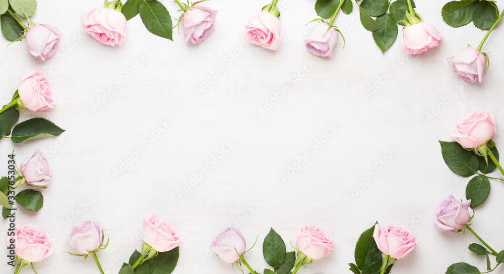 Flowers valentine day composition. Frame made of pink rose on gray background. Flat lay, top view, copy space.
