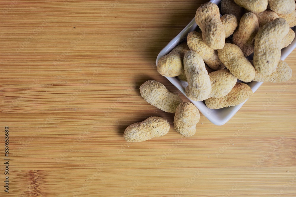 Fototapeta premium Peanuts on small rectangular porcelain plate