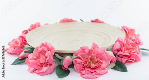 Wooden dish. The plate is decorated with flowers. Festive decoration.