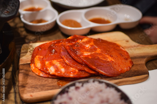 The raw meat with spices on the wooden plate in the restaurant in Melbourne, Australia