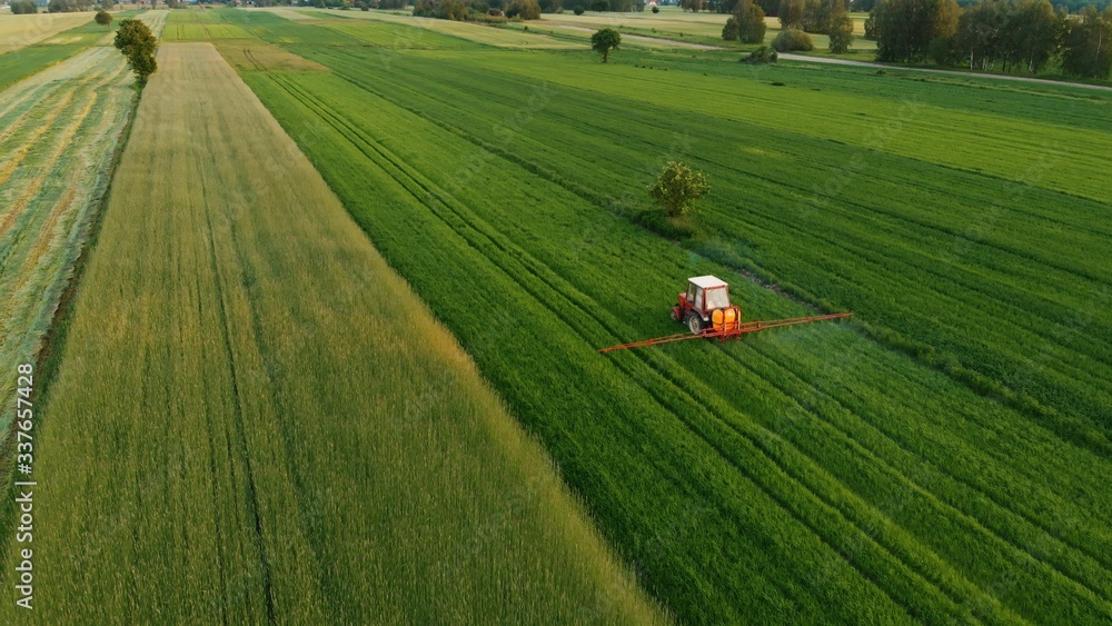 Tractor spray stubble field with herbicide chemicals in spring. Tractor spray stubble field with herbicide chemicals in spring.