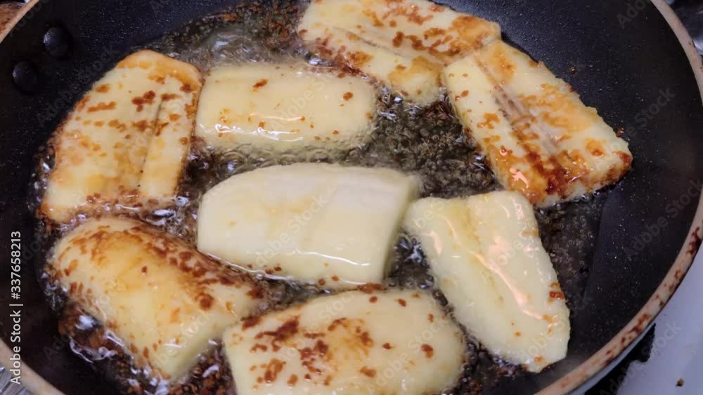 Cooking bananacue in a pan with brown sugar Cooking bananacue in a pan with brown sugar