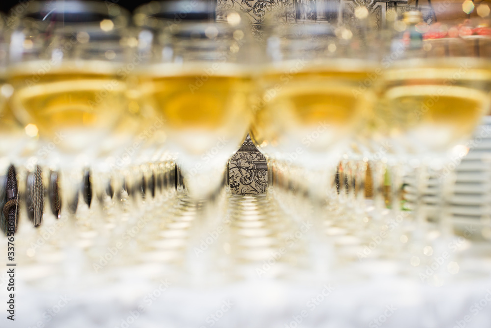 Number of wine glasses on the table in the restaurant. Champagne in glasses Number of wine glasses on the table in the restaurant. Champagne in glasses