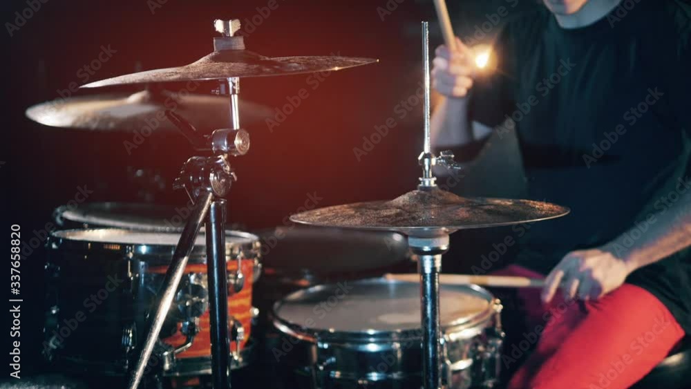 One drummer rehearsing in a studio. Drummer, drumset, drums in slow motion One drummer rehearsing in a studio. Drummer, drumset, drums in slow motion