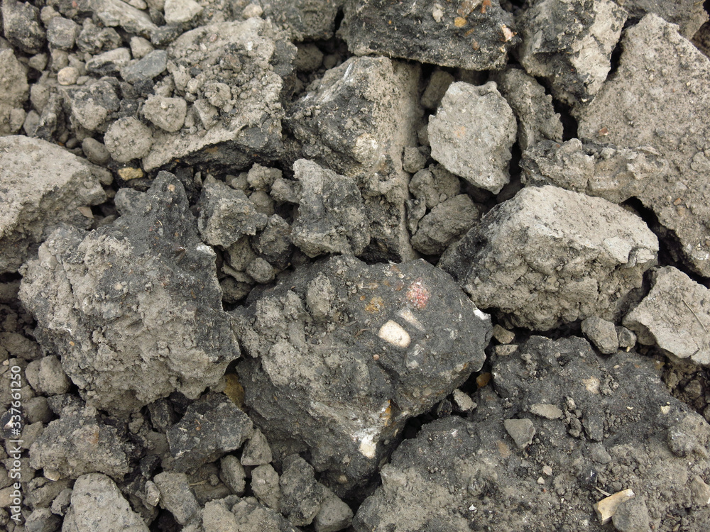 broken gray chunks of asphalt in a pile