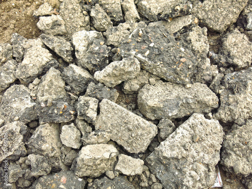 broken gray chunks of asphalt in a pile