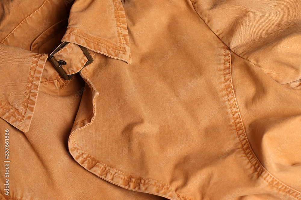 Beige denim jacket. Collar, clasp. Denim. Fragment, close-up