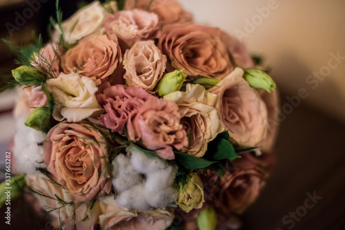 Bridal bouquet in a classic style: roses, eustoma, cotton 