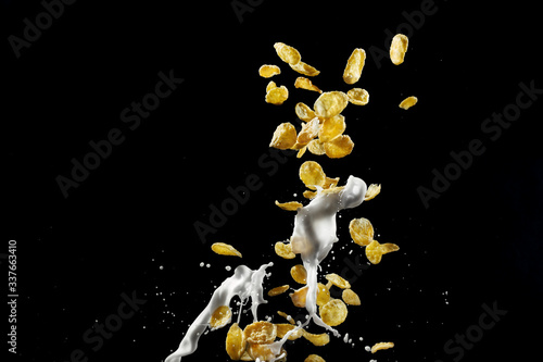 Cornflakes with milk, black background