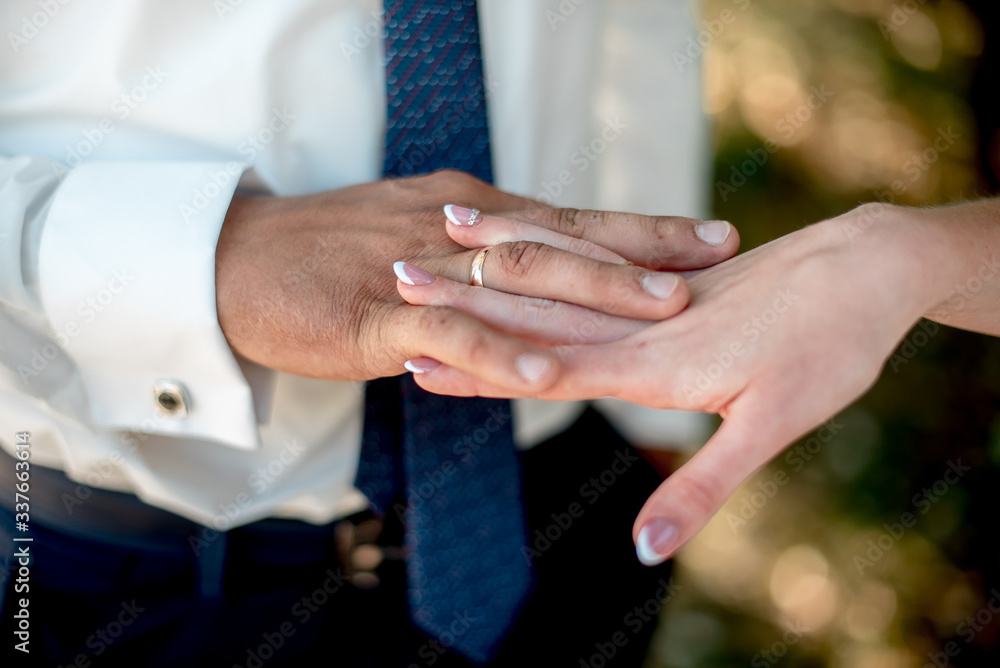 The rings on the hands of the newlyweds
