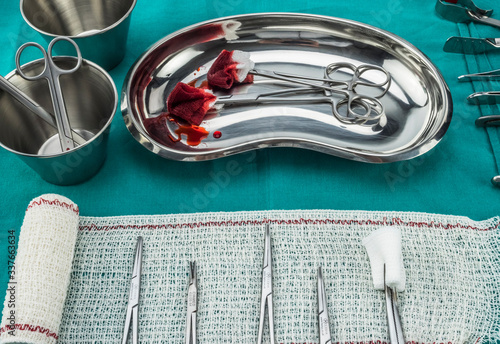 Obraz na plátně Scissors surgical with torundas soaked with blood on a tray metal in an operatin