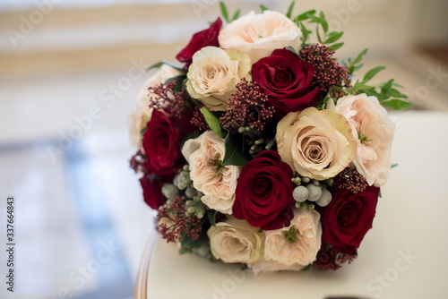 Bridal bouquet of red and cream roses  eustoma and ornamental plants 