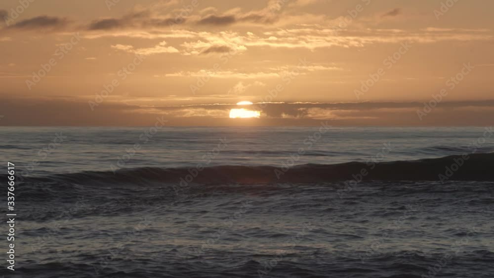 Beautiful sunset over the horizon on the Hokitika sea, New Zealand Beautiful sunset over the horizon on the Hokitika sea, New Zealand