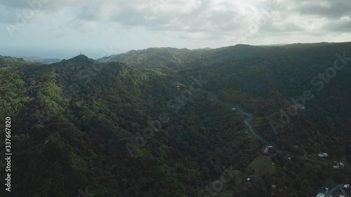 Beautiful landscape drone shot of the coastal terrain of Tyrrel's Bay and the steep mountain road into Speyside, Tobago, West Indies. photo