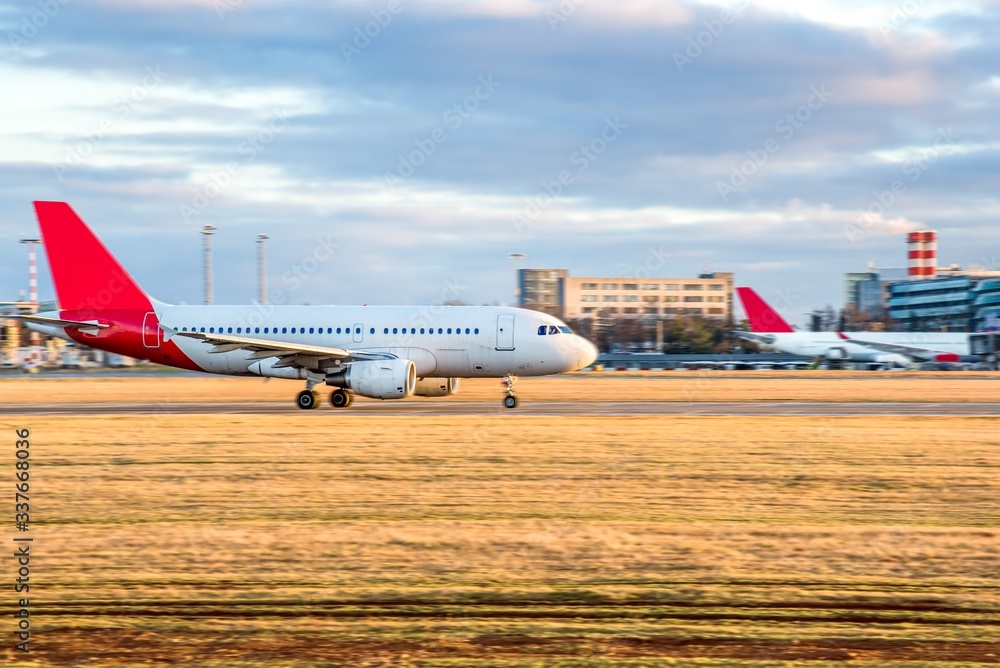 Fototapeta premium Aircraft take-off into the sky against the background of the airport