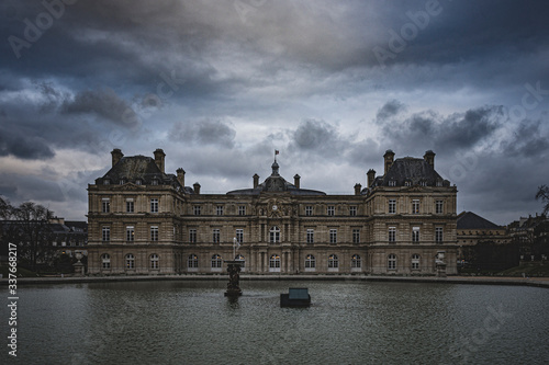palace with pond on a dark and dramatic day, with clouds threatening rain and darkness photo