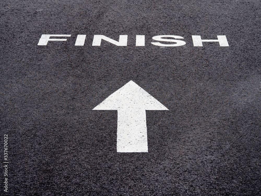 white finish and white arrow on black asphalt white finish and white arrow on black asphalt
