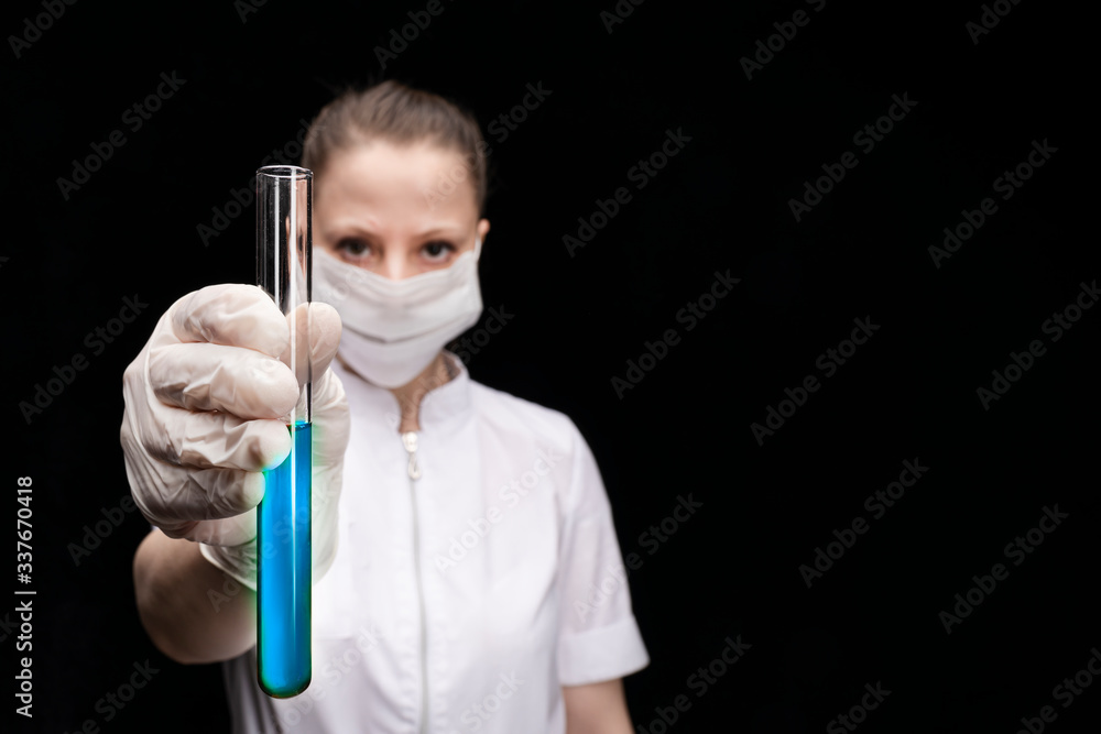 a test tube with the results of the analysis for covid 19 coronavirus in the hands of the doctor's girl. Girl in a blur. copy space a test tube with the results of the analysis for covid 19 coronavirus in the hands of the doctor's girl. Girl in a blur. copy space