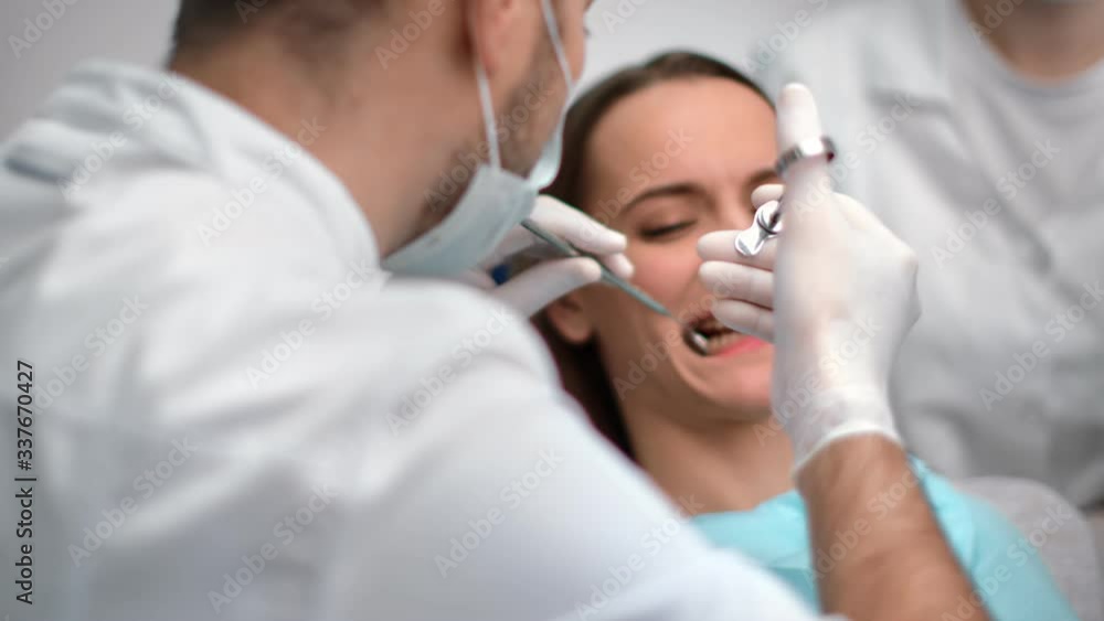 Dentist making dental syringe injection to patient before treating teeth. Shot with RED camera in 4K Dentist making dental syringe injection to patient before treating teeth. Shot with RED camera in 4K