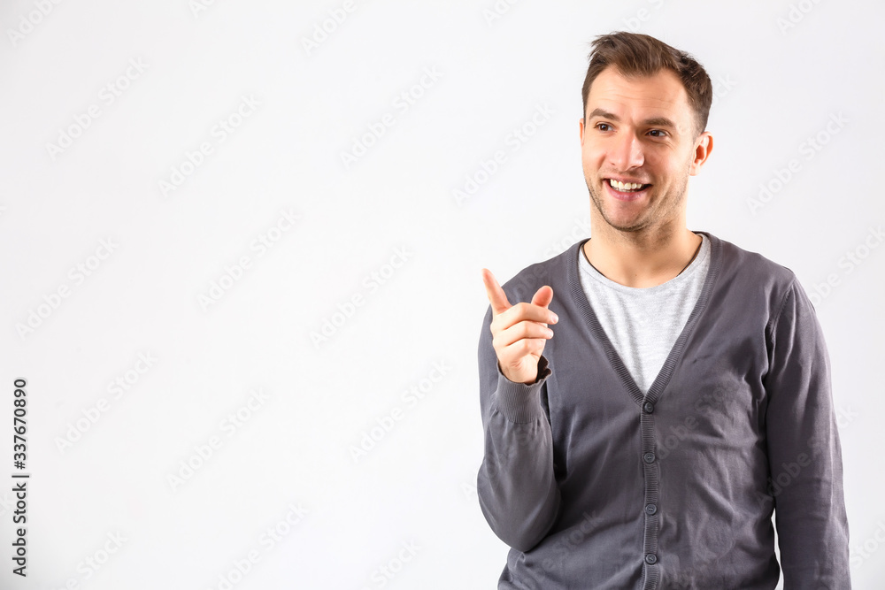 Young man presenting your product, isolated over a white background Young man presenting your product, isolated over a white background