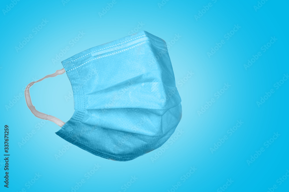 Medical mask on a blue background. Corona virus protection concept. Respiratory medical respiratory textile protective mask. Medical mask on a blue background. Corona virus protection concept. Respiratory medical respiratory textile protective mask.