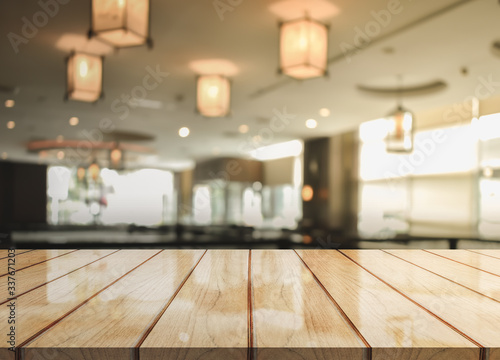 Wooden top table with bokeh light effect and blur restaurant on background  blur background