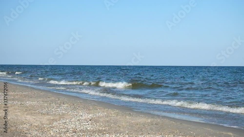 Sea surf. Sea waves smoothly roll onto the sandy shore. Black Sea