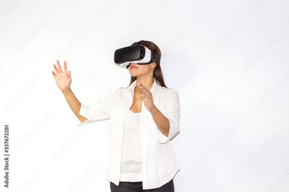 Beautiful girl uses Virtual Reality a helmet with surprise and enthusiasm Beautiful girl uses Virtual Reality a helmet with surprise and enthusiasm