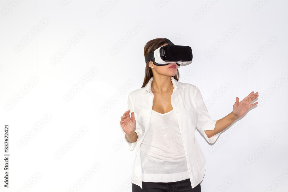Beautiful Girl tries VR headset on white background Beautiful Girl tries VR headset on white background