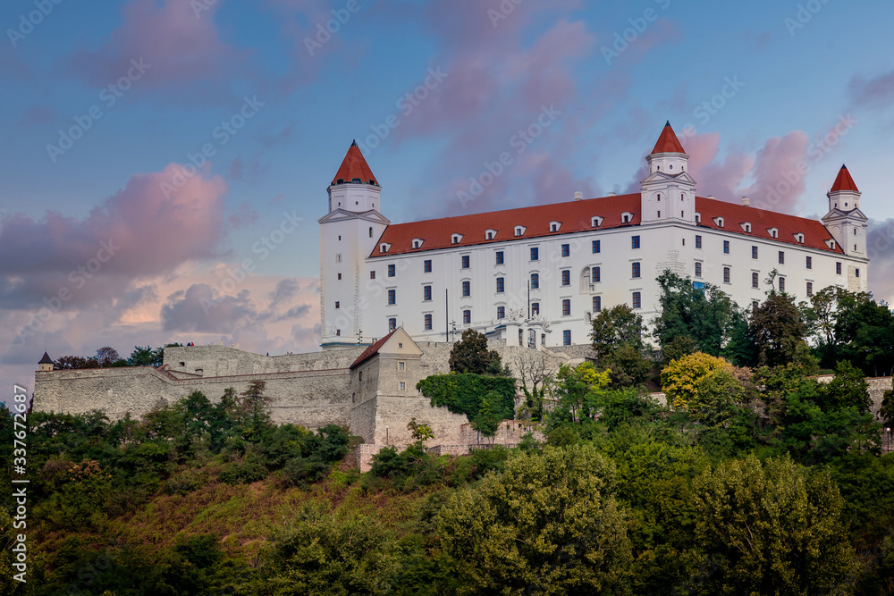 Evening view of the old famous  Bratislava Castle up on the hill with surrounding wall.