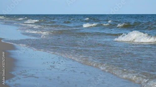 Sea surf. Sea waves smoothly roll onto the sandy shore. Black Sea