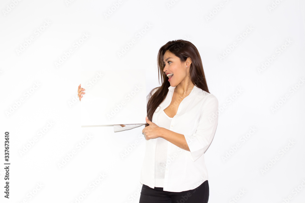 Beautiful girl hold a white board billboard smiling and is amazed surprised and happy Beautiful girl hold a white board billboard smiling and is amazed surprised and happy