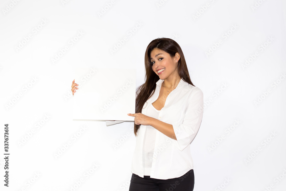 Beautiful girl hold a white board billboard smiling and is amazed surprised and happy Beautiful girl hold a white board billboard smiling and is amazed surprised and happy