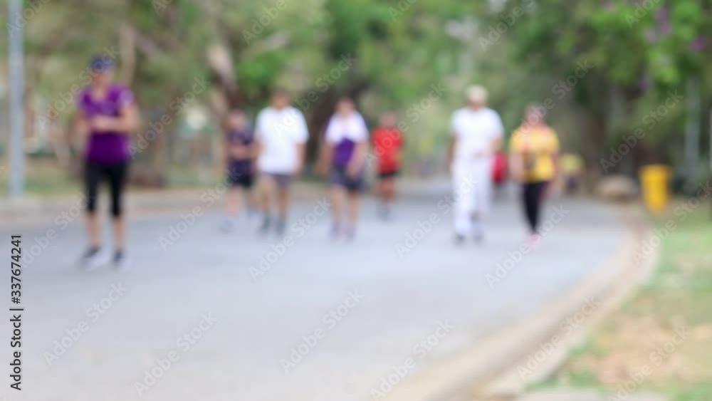 People walking in the park. Exercising background. People walking in the park. Exercising background.