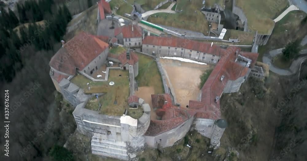 Pan down moody medieval castle turned into a fort, commanding a mountain pass Pan down moody medieval castle turned into a fort, commanding a mountain pass