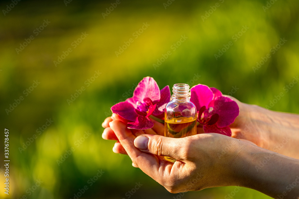 Beautiful woman and organic cosmetic. Space for text. Woman holding bottle of aroma oil, closeup.