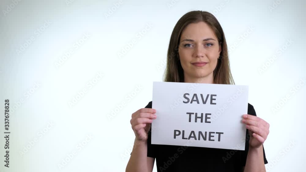 Pretty brunette girl in a black T-Shirt hold a sign Pretty brunette girl in a black T-Shirt hold a sign