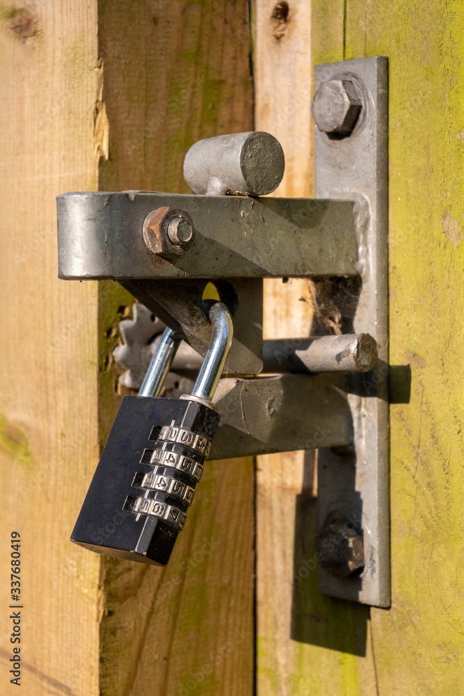 Combination padlock securing a wooden gate Combination padlock securing a wooden gate