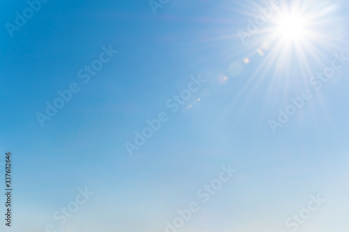 Clear blue sky with sun and sunrays. Daytime and good weather