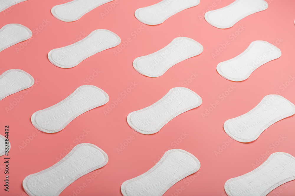 Sanitary pad on a pink background in the form of a diagonal pattern. Textured background over the entire screen. Sanitary pad on a pink background in the form of a diagonal pattern. Textured background over the entire screen.