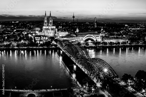 Cologne, Germany: Beautiful panoramic aerial night landscape of the gothic catholic Cologne cathedral, Hohenzollern Bridge and the River Rhine at sunset, golden hour and blue hour.