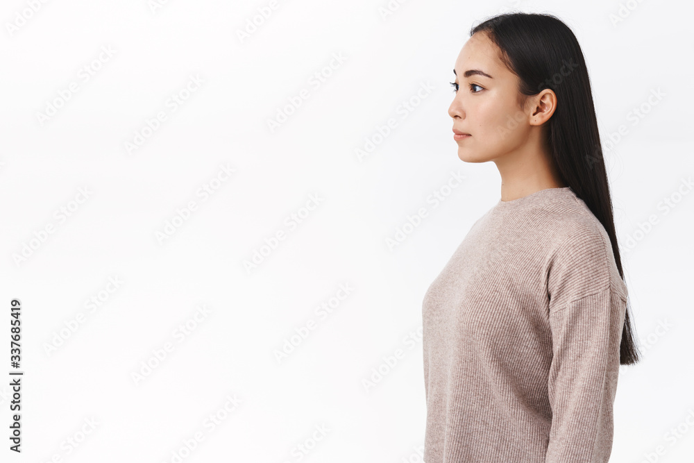 Profile studio shot girl stand casually in winter sweater, looking left as waiting in queue for morning coffee near cafe counter, posing with straight posture and normal expression, white background Profile studio shot girl stand casually in winter sweater, looking left as waiting in queue for morning coffee near cafe counter, posing with straight posture and normal expression, white background